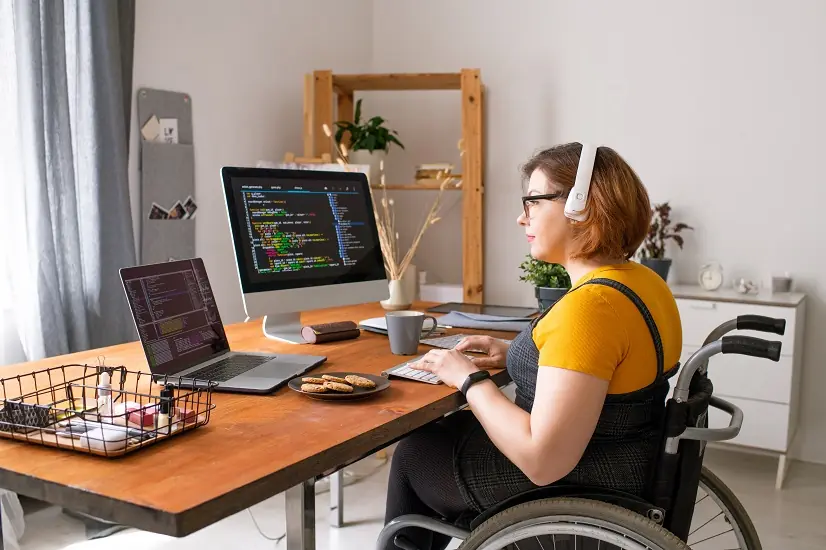 employee in wheelchair sitting at desk