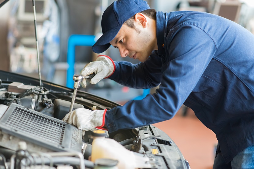 Autoworker fixing a car