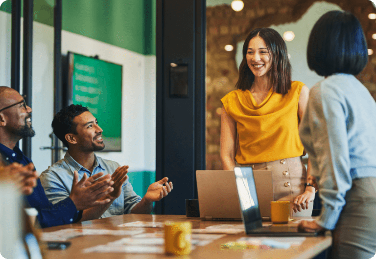 Stock image employees collaborating at desk