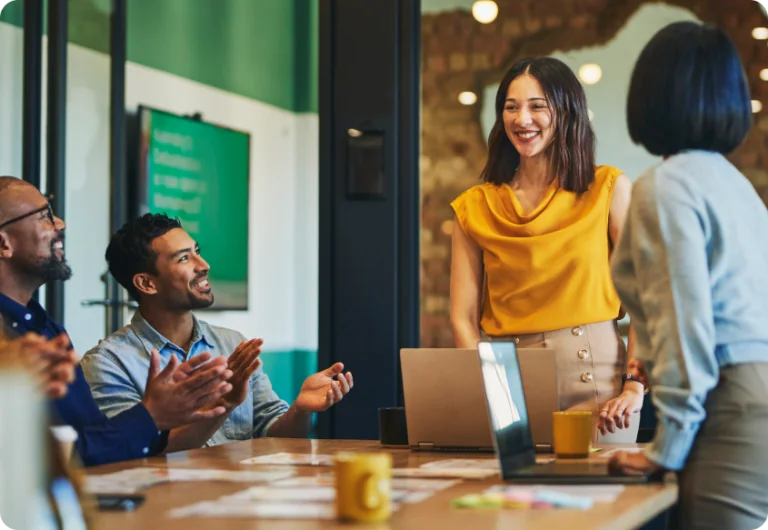 Stock image employees collaborating at desk