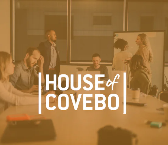 A group of employees brainstorming in the background with the company logo in front of the picture