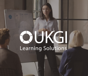 UKGI learning solutions white logo with presentation background